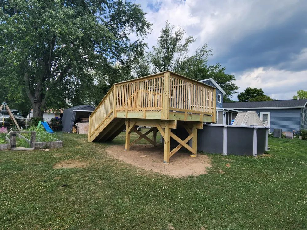 Raised timber deck with railings and stairs down to the lawn