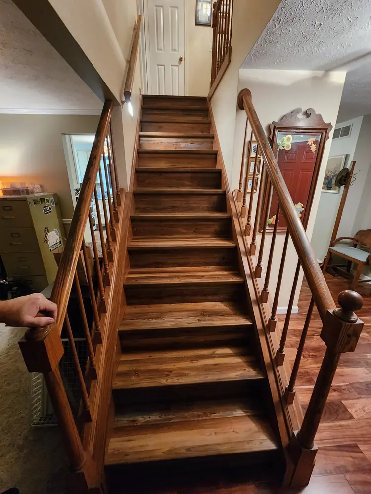 Wood staircase with turned balusters and a shaped handrail